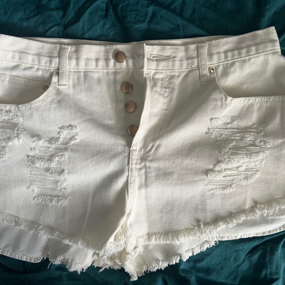 White high waist distressed shorts with gold button details